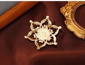 Detailed back view of the vintage golden lotus flower brooch showing the safety pin