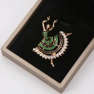 Close-up of elegant ballet dancer brooch with green enamel and clear rhinestones