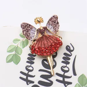 Detailed macro view of an elegant ballet girl brooch with sparkling red and purple rhinestones.