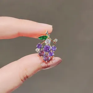 Exquisite purple grape brooch pin with sparkling zircons and green leaf detail.
