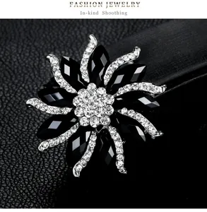 Detail view of a black flower alloy brooch with sparkling crystal rhinestones inlay.