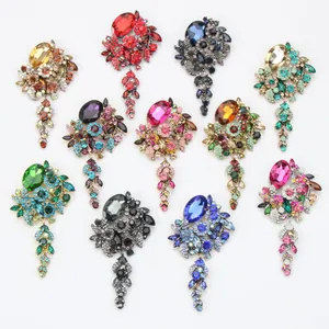 Detailed close-up display of vintage rhinestone tassel brooches in vibrant colors