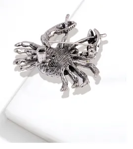 Close-up detail view of the back of a vintage silver crab brooch with secure pin.