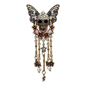 Vintage-Brosche aus Bronze mit Totenkopf, Schmetterlingsflügeln und bunten Strass-Quasten