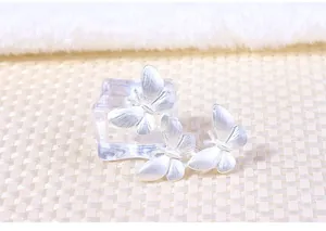 Macro view of three silver alloy butterflies on a stylish fashion brooch