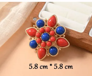 Detailed view of an ethnic lotus brooch featuring red and blue stones, size 5.8cm.
