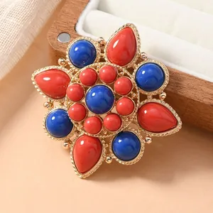 Ethnic style lotus flower brooch with red and blue faux turquoise stones on gold alloy