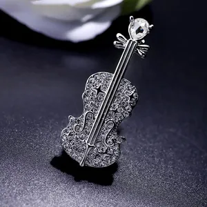 Detailed macro view of a sparkling crystal violin brooch on a dark background