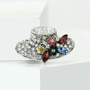 Detailed view of retro rhinestone sun hat brooch with colorful floral accents
