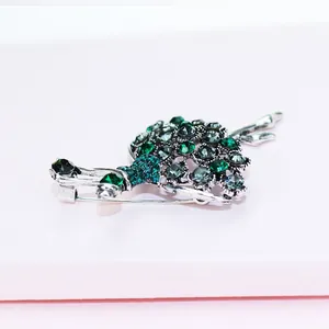 Detailed macro shot of a green rhinestone ballet dancer girl brooch jewelry accessory
