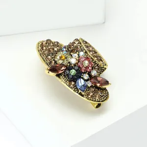Macro view of vintage alloy sun hat brooch decorated with colorful sparkling rhinestones