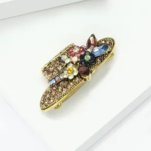 Detailed macro view of a vintage alloy sun hat brooch with colorful rhinestones