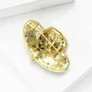 Close-up view of the back metal structure and pin fastener of a vintage golden hat brooch