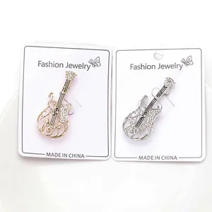Creative guitar-shaped alloy brooches with sparkling rhinestones in gold and silver tones.