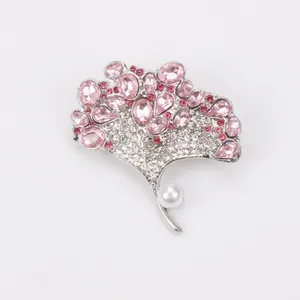 Elegant silver finish ginkgo leaf brooch featuring pink crystals and a central white pearl