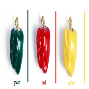 Detail of crystal encrusted bell pepper brooches in green, red, and yellow colors
