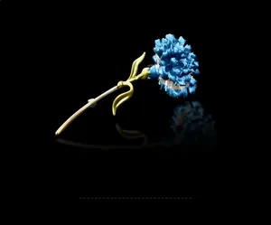 Detailed view of an elegant blue and gold carnation flower brooch pin for suits