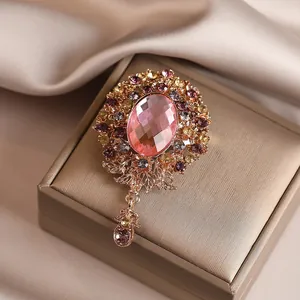 Elegant vintage glass rhinestone alloy flower brooch with dangling pink gem