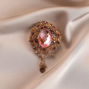 Elegant vintage pink crystal flower brooch with multicolored rhinestones on silk cloth