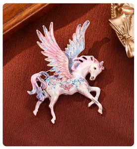 Close-up of a whimsical oil-painted Pegasus brooch with vibrant pink and blue wings
