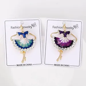 Detailed view of two elegant ballet dancer brooches in blue and purple enamel with crystals