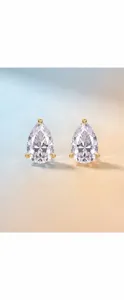 Close-up of elegant pear-cut moissanite stud earrings in 925 silver setting