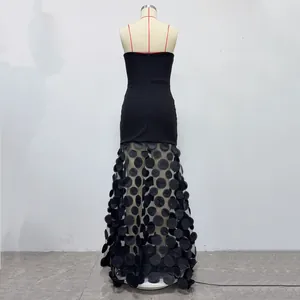 Back view of black strapless evening gown with 3D floral appliqué sheer skirt.