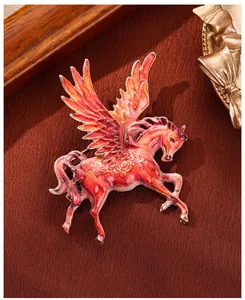 Close-up of an exquisite red enamel winged Pegasus brooch with detailed oil-painted finish.