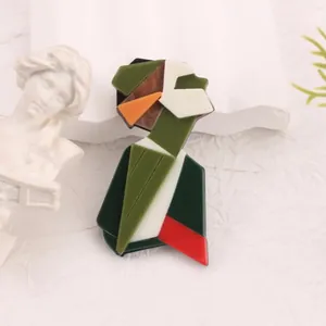 Macro detail shot of an abstract geometric acrylic brooch with artistic portrait design.