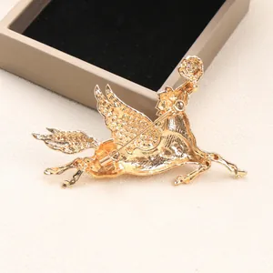 Detailed view of the back mechanism of a vintage golden pegasus brooch pin