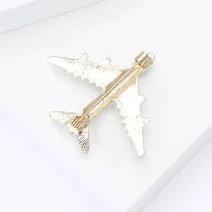 Detailansicht der Rückseite einer goldenen Flugzeugbrosche mit Sicherheitsnadel