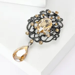 Close-up detail of a vintage style champagne crystal brooch with antique silver finish.