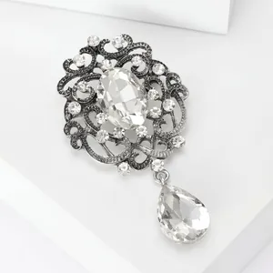 Detailed view of vintage silver alloy brooch with oval and teardrop crystal accents
