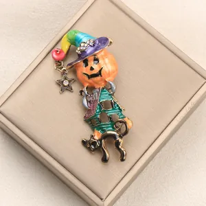 Vintage Halloween enamel brooch featuring a pumpkin witch hat and black cat charm