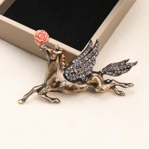Vintage Pegasus brooch with rhinestone wings and a red rose, mythology jewelry for suits.