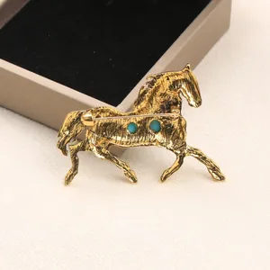 Vintage gold-toned alloy horse brooch with imitation turquoise stones for coats