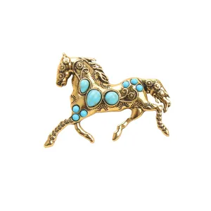 Vintage golden running horse brooch with turquoise-style stones for coats and jackets.