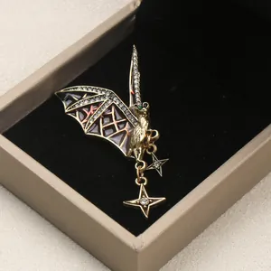 Vintage gothic bat brooch with sparkling rhinestones and hanging stars in jewelry box