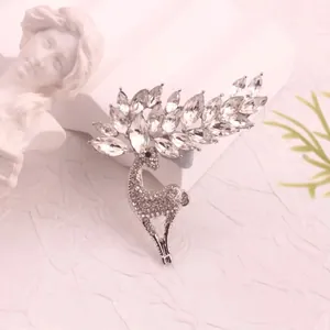 Detailed macro shot of vintage silver deer brooch with sparkling crystals