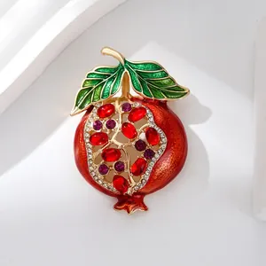 Elegant pomegranate brooch with red rhinestones and green enamel details for women.