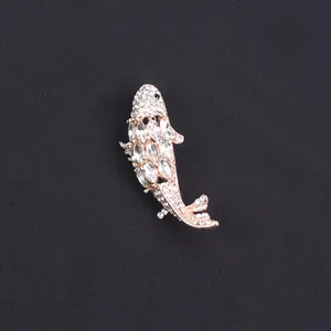 Macro detail view of a sparkling rhinestone koi fish brooch pin with rose gold finish