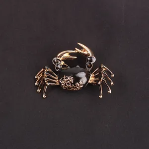 Macro detail showing the intricate gold pattern and black enamel finish on this crab brooch