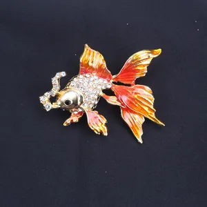 Detailed view of goldfish brooch featuring sparkling rhinestones and vibrant orange enamel