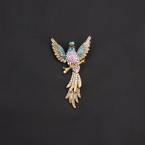 Detail van een vintage kolibrie broche met paarse en blauwe strassteentjes.