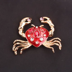 Detailed macro view of a gold-toned enamel crab brooch adorned with sparkling stones