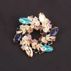 Detailed view of a vibrant floral wreath brooch featuring multi-colored rhinestones.