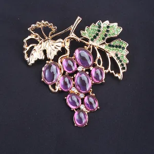 Exquisite macro detail of a vintage gold-toned grape brooch with purple gemstones