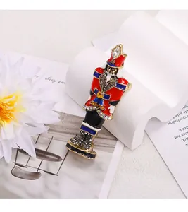 Detail showing a colorful nutcracker soldier brooch with rhinestone embellishments