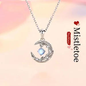 Close-up of elegant crescent moon pendant with light blue moonstone detail