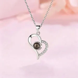 Elegant silver heart-shaped necklace featuring I love you projection in 100 languages